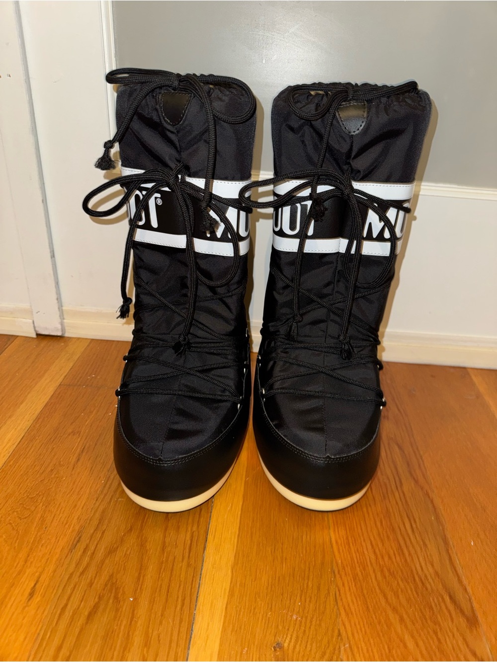Black MOON BOOTS with white detailing